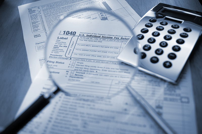 Tax documents and calculator representing strategic tax preparation and planning for small businesses